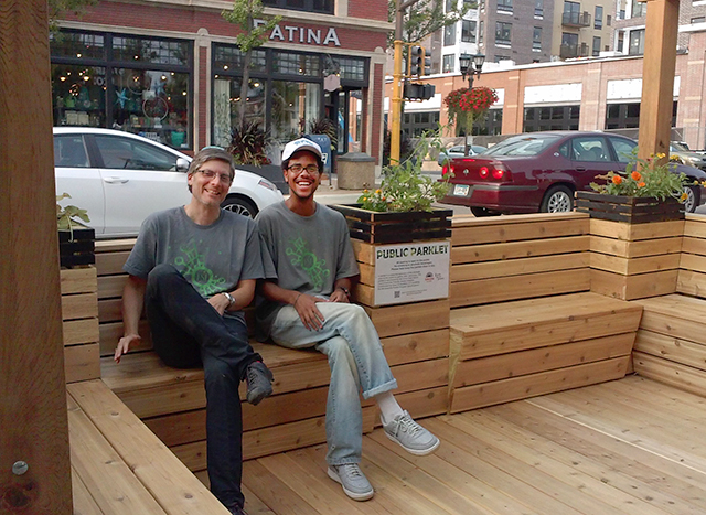 Friendly Street Initiative director Lars Christiansen and organizer Darius Gray relax at a temporary parklet built in Selby Avenue.